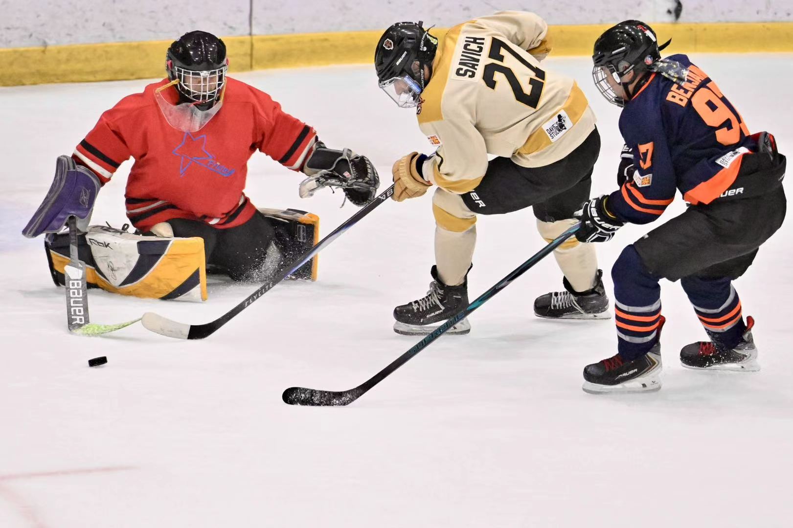JY tracking the puck as Bulls and Oilers players battle in front of the crease